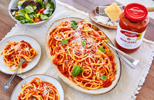 Load image into Gallery viewer, A platter of spaghetti with a jar of Mezzetta Family Recipes Family Size Marinara
