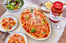 Load image into Gallery viewer, A platter of spaghetti with a jar of Mezzetta Family Recipes Family Size Marinara