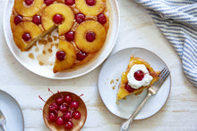 Load image into Gallery viewer, Pineapple Upside Down Cake with a slice taken out and put on a plate
