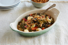 Load image into Gallery viewer, A ramekin of Braised Greens with Pancetta and Giardiniera on a linen table cloth 
