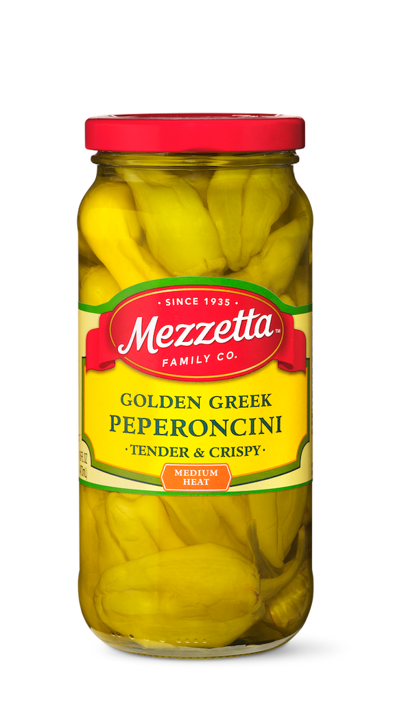 A jar of Mezzetta Golden Greek Pepperoncini peppers sits on display, showcasing the vibrant yellow peppers ready to add a medium heat and crispy texture to any dish.