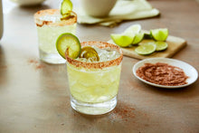 Load image into Gallery viewer, Bartender shakes up a refreshing margarita with a chili-lime rim and fresh garnish.