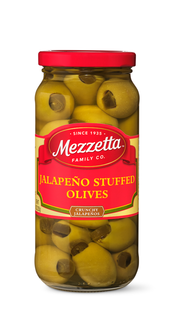 A glass jar filled with Mezzetta brand jalapeno-stuffed green olives.