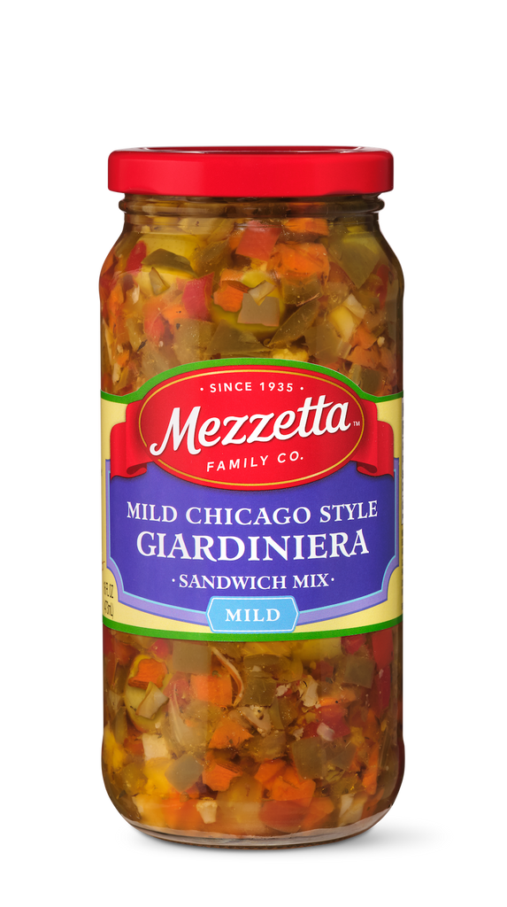 A glass jar filled with Mezzeta brand Mild Chicago Style Giardiniera sandwich mix. The jar shows colorful diced vegetables including carrots, peppers, and cauliflower.