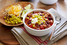 Load image into Gallery viewer, Roasted Garlic Turkey Chili topped with sour cream and Mezzetta Diced Jalapeno Peppers