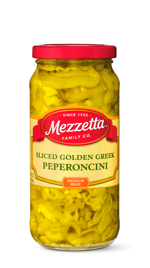 A glass jar displays sliced golden Greek pepperoncini from Mezzetta Family Co., promising a medium heat flavor.