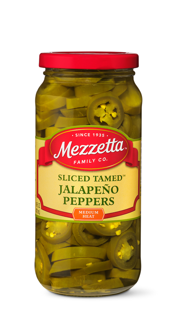 A glass jar displays sliced, pickled jalapeno peppers from Mezzetta Family Co.