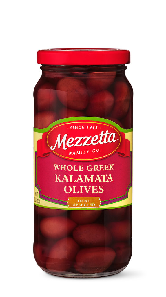A clear glass jar displays hand-selected, whole Greek Kalamata olives from Mezzetta Family Co.