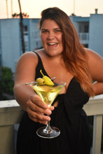 Load image into Gallery viewer, Woman holding a martini topped with Mezzetta Jalapeno Stuffed Olives and Hot Chili Peppers

