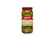 A clear glass jar filled with Mezzetta Super Colossal Spanish Queen whole olives. The jar features a red lid and a label highlighting 