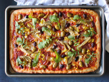 Load image into Gallery viewer, A sheet pan with a Antipasti Sheet Pan Pizza on it.
