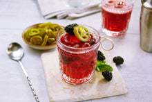 Load image into Gallery viewer, A glass of Blackberry Jalapeno Smash with a bowl of jalapenos
