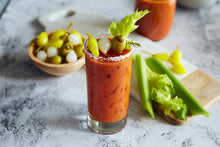 Load image into Gallery viewer, Mezzetta Bloody Mary served with Hot Chili Peppers, Cocktail Onions, and Jalapeno Stuffed Olives
