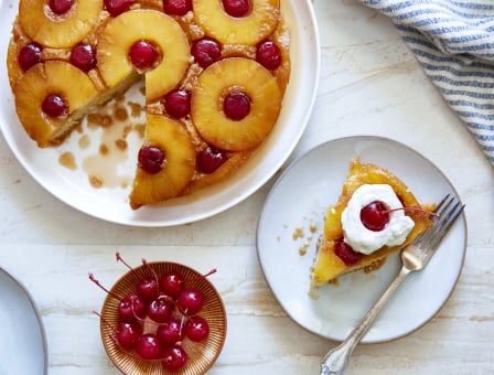 A slice of Pineapple Upside Down Cake out of a larger cake