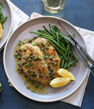 Load image into Gallery viewer, Two pieces of Chicken Piccata served with green beans and lemons

