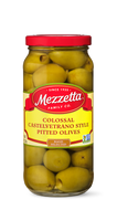 A glass jar filled with Mezzetta brand Colossal Castelvetrano Style Pitted Olives. The jar showcases the large, green olives through the glass. 

