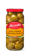 A glass jar brims with hand-selected green olives stuffed with feta cheese, showcasing the Mezzetta Family Co. brand. 

