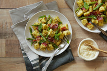 Load image into Gallery viewer, Handmade Gnocchi with Pesto and Crispy Prosciutto with a side of parmesan cheese
