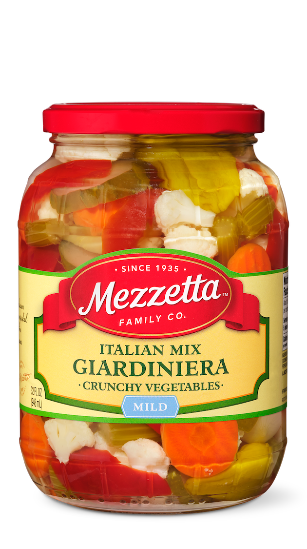 A clear glass jar displays a colorful mix of Mezzeta brand Mild Italian Mix Giardiniera. Crunchy cauliflower, peppers, carrots, and celery are packed in oil. 
