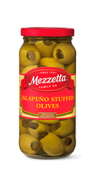 A glass jar filled with Mezzetta brand jalapeno-stuffed green olives. 
