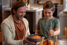 Load image into Gallery viewer, Son serving his dad a bowl of spaghetti with Mezzetta Marinara Sauce
