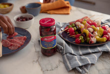 Load image into Gallery viewer, Jar of Mezzetta Pitted Greek Kalamata Olives next to antipasto skewers
