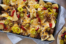 Load image into Gallery viewer, A sheet pan covered in loaded nachoes
