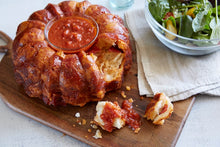 Load image into Gallery viewer, Pizza Party Bread served on a wooden board with Mezzetta pizza sauce for dipping
