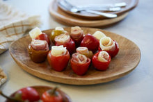 Load image into Gallery viewer, Stuffed cherry peppers on a wooden plate
