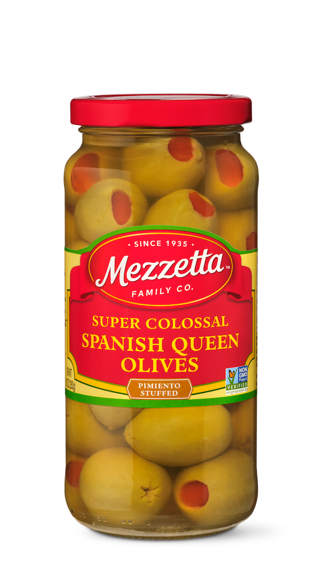 Glass jar filled with Mezzetta Super Colossal Spanish Queen Olives stuffed with pimentos. 
