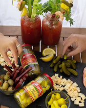 Load image into Gallery viewer, Two Bloody Marys next to a charcuterie board with Mezzetta Hot Chili Peppers and Super Colossal Spanish Queen Olives
