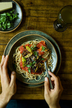 Load image into Gallery viewer, Hands ready to start eating a bowl of spaghetti with Mezzetta Marinara and peperoncinis
