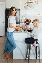 Load image into Gallery viewer, Mom and daughter enjoying food made with Mezzetta products in their kitchen
