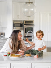 Load image into Gallery viewer, Mom and son laughing while enjoying a quiche with Mezzetta Artisan Ingredients Basil Pesto
